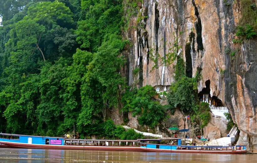 Luang Prabang: Pak Ou Caves & Kuang Si Falls Day Trip - Entering Pak Ou Caves: statues, incense, and stairs